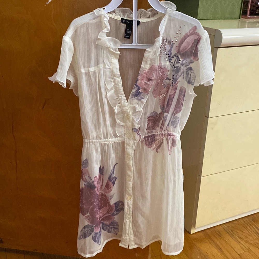 Sheer blouse with rhinestone details.